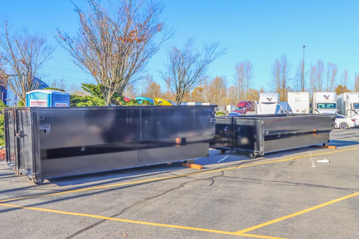 Professional dumpster rental service with roll-off container on residential driveway in Vancleave